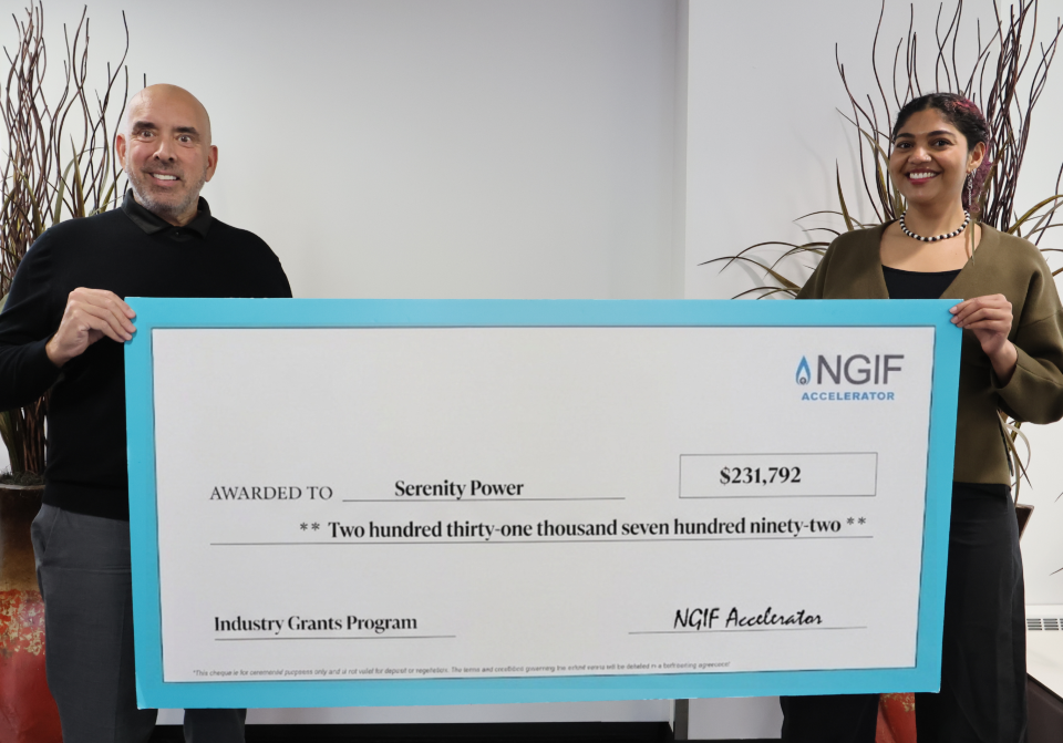 From left, John Adams, President and CEO of NGIF Accelerator, and Aleisha Reese Cerny at the NGIF Accelerator office in Calgary holding a big cheque.